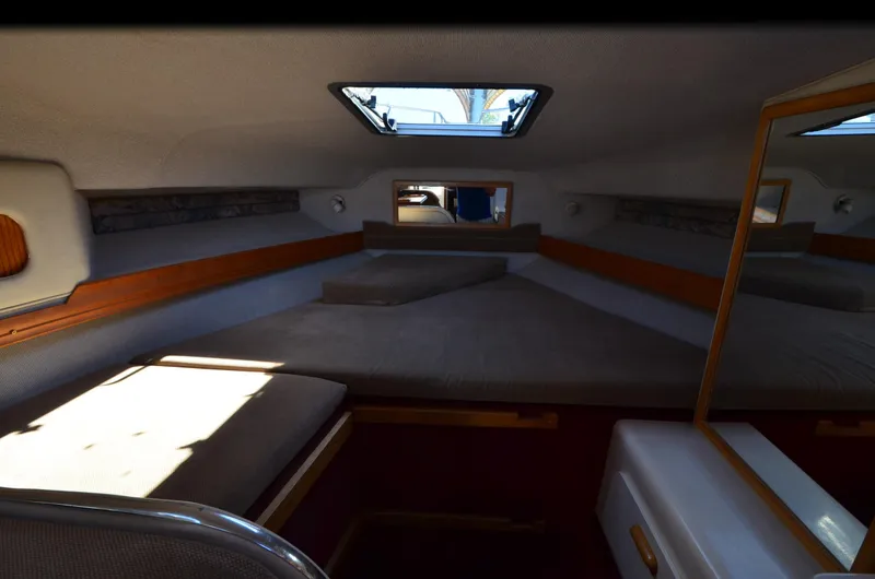 Slide: The Image of Interior cabin of 1992 Sea Ray 290 Sundancer boat with cozy sleeping area. - 7