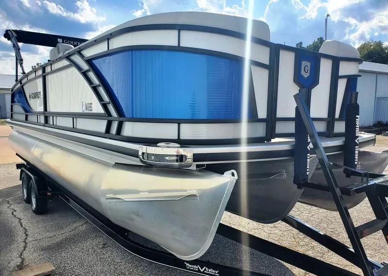 Slide: The Image of 2021 Godfrey Monaco 235RL triple tube pontoon boat on trailer, sunny day. - 6