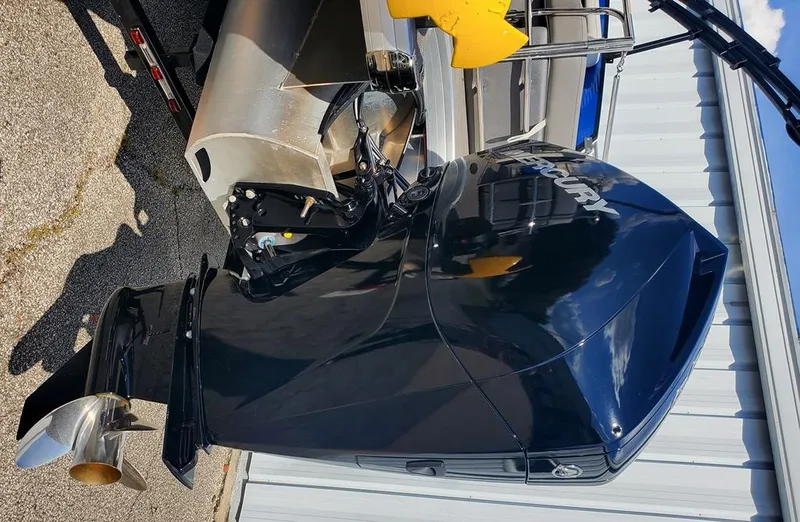 Slide: The Image of 2021 Godfrey Monaco 235RL boat with Mercury outboard motor, parked on trailer. - 9
