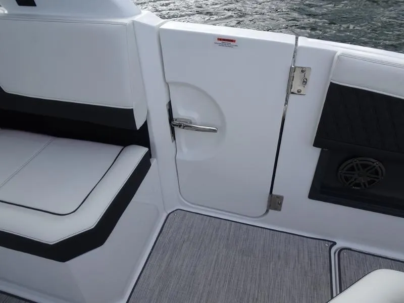 Slide: The Image of Interior of 2025 Cobalt R33 boat with white seating and door. - 13