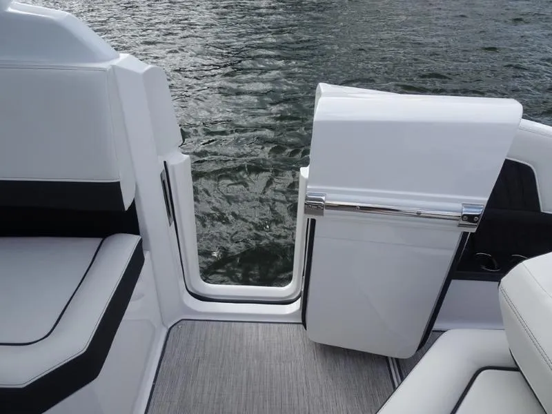Slide: The Image of Cobalt R33 2025 boat interior with open door, showcasing sleek design and water view. - 14