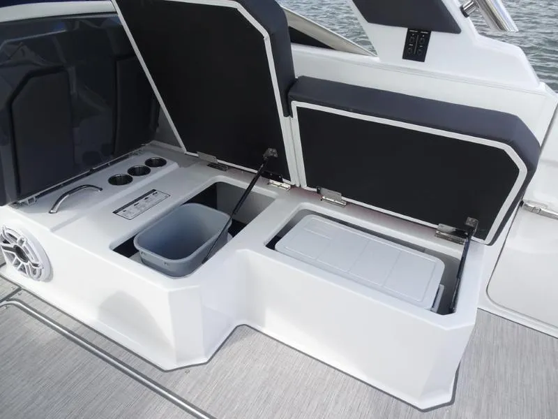 Slide: The Image of 2025 Cobalt R33 boat storage compartments with cooler and trash bin. - 15