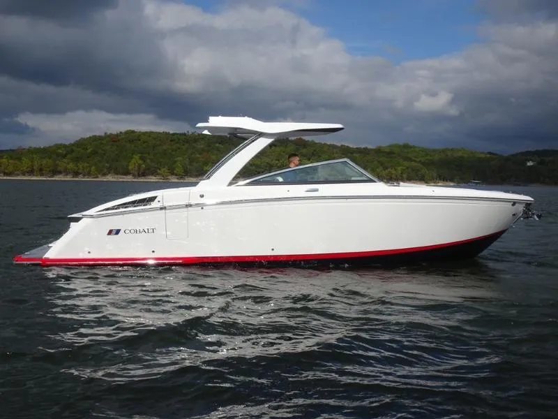 Slide: The Image of 2025 Cobalt R33 boat on a lake with scenic background. - 2
