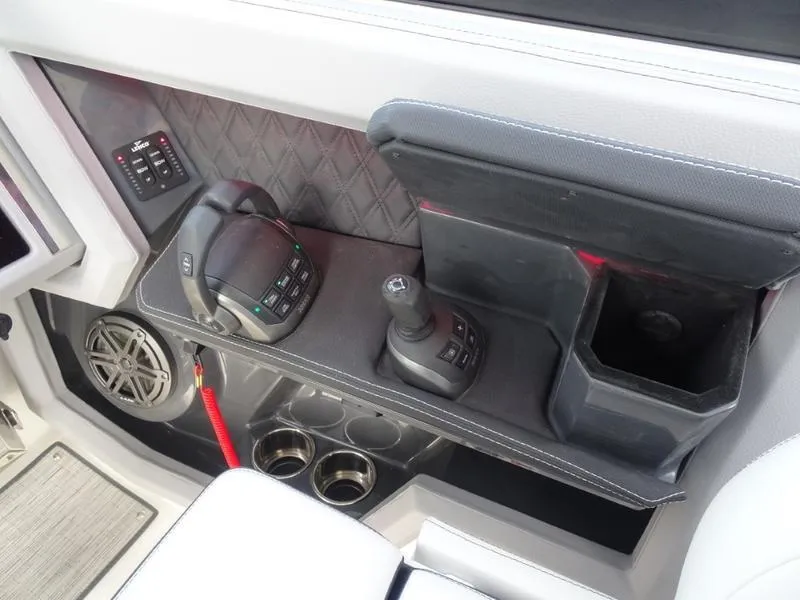 Slide: The Image of 2025 Cobalt R33 boat console with joystick, controls, and cup holders. - 27