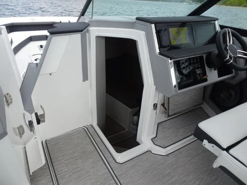 Slide: The Image of Interior of 2025 Cobalt R33 boat, featuring modern helm and cabin entrance. - 29