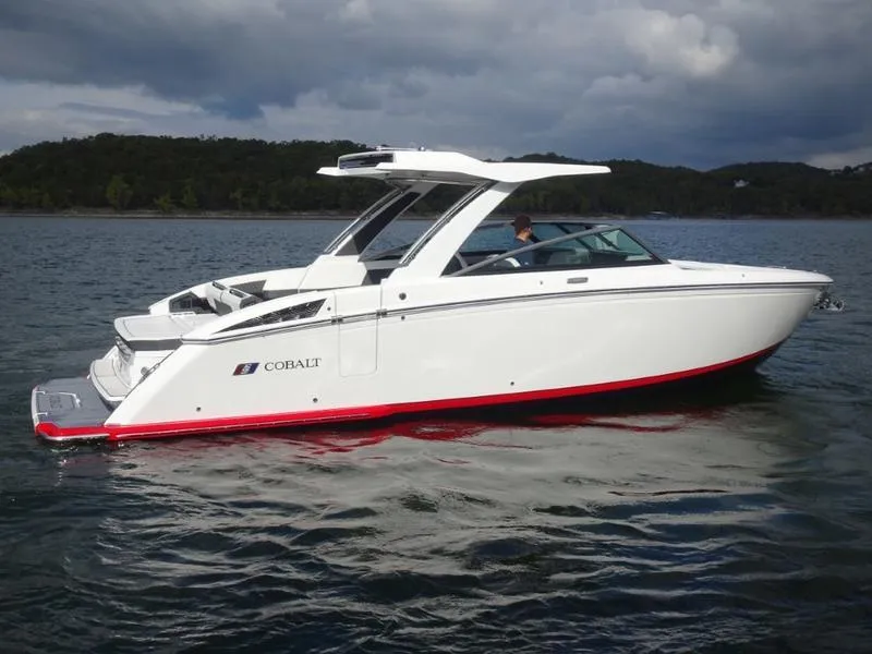 Slide: The Image of 2025 Cobalt R33 boat on water, sleek white design, overcast sky. - 3