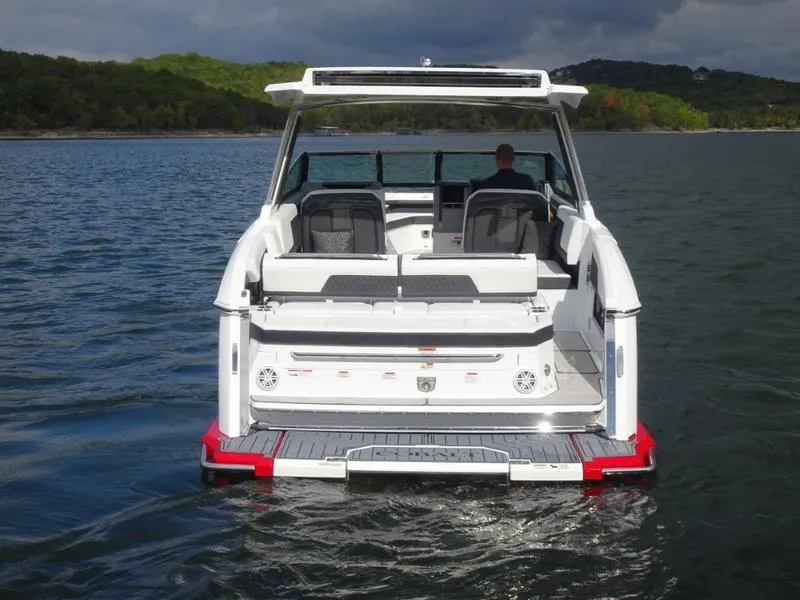 Slide: The Image of 2025 Cobalt R33 boat on a lake, rear view with seating and swim platform. - 5