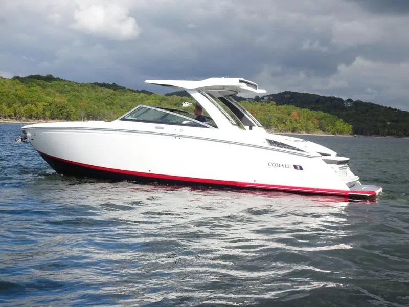 Slide: The Image of 2025 Cobalt R33 boat on a lake with lush green shoreline. - 6