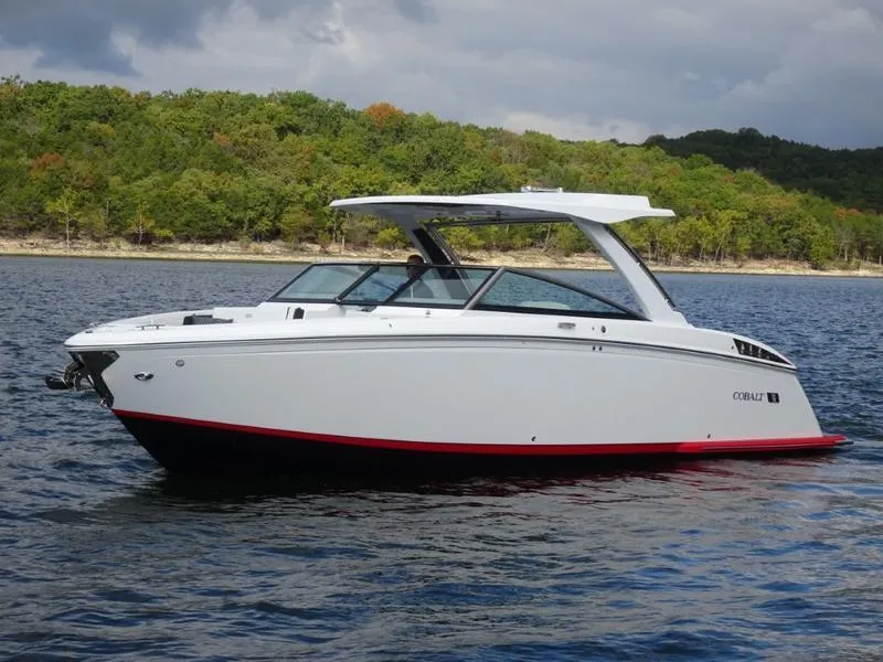Slide: The Image of 2025 Cobalt R33 boat on a lake with forested shoreline. - 8