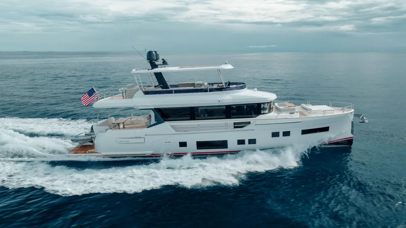 Slide: The Image of Luxurious 2023 Sirena 68 yacht cruising on open sea under cloudy skies. - 12