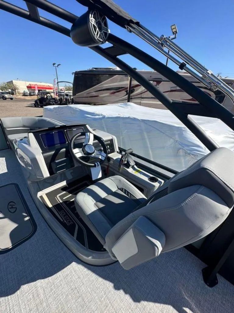 Slide: The Image of 2024 Harris Solstice 230 boat interior with modern helm and seating. - 5