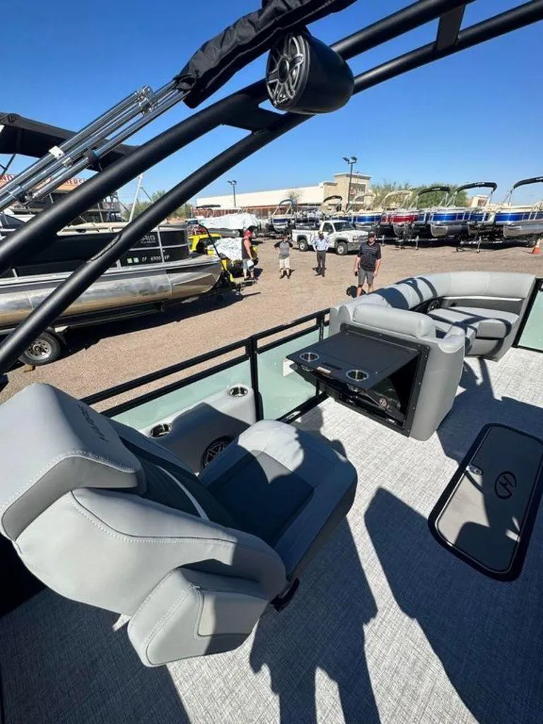 Slide: The Image of 2024 Harris Solstice 230 pontoon boat interior with plush seating and cup holders. - 9