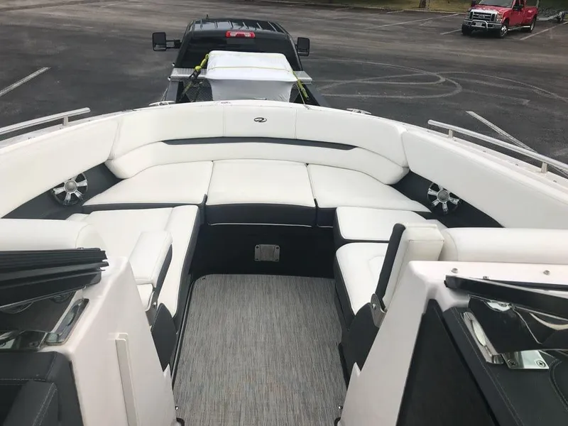 Slide: The Image of 2017 Regal 29 OBX boat interior with white seating and carpeted floor. - 4