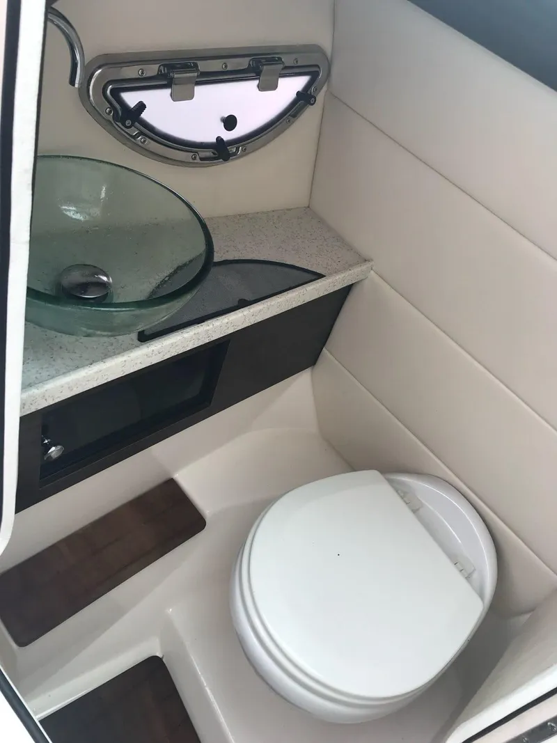 Slide: The Image of 2017 Regal 29 OBX boat bathroom with modern sink and toilet. - 5