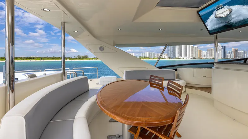 Slide: The Image of Luxurious Azimut 100 Jumbo yacht interior with ocean view, featuring elegant seating and a wooden table. - 40