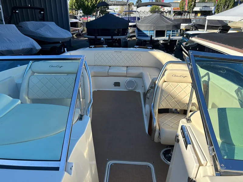 Slide: The Image of 2015 Chris-Craft Launch 28 boat interior with cream leather seating and open deck. - 14