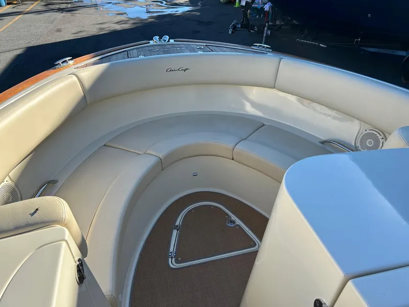 Slide: The Image of 2015 Chris-Craft Launch 28 boat interior with beige seating and wood accents. - 15