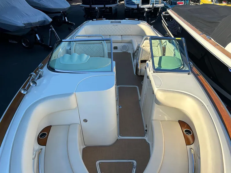 Slide: The Image of 2015 Chris-Craft Launch 28 boat interior with white seating and wood accents. - 17