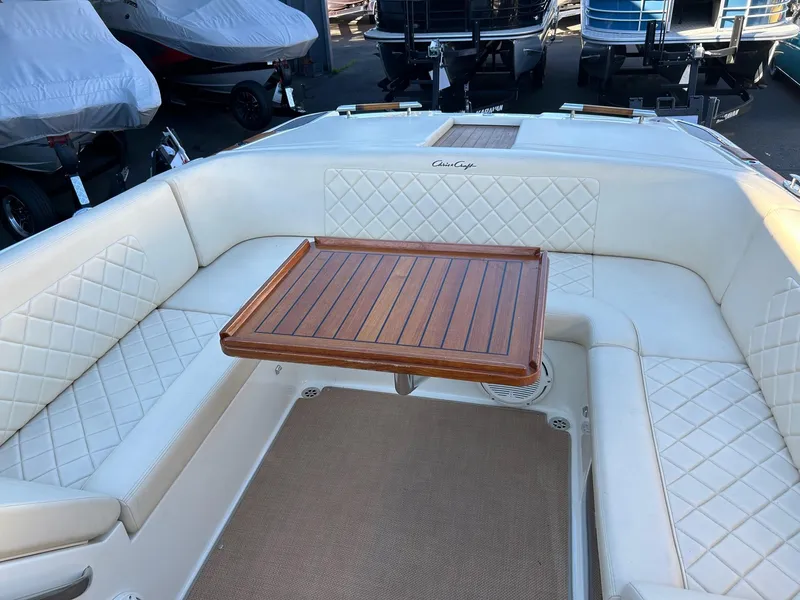 Slide: The Image of 2015 Chris-Craft Launch 28 interior with white seating and wooden table. - 21