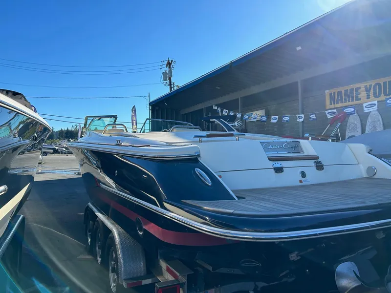 Slide: The Image of 2015 Chris-Craft Launch 28 boat on trailer in sunny outdoor setting. - 6
