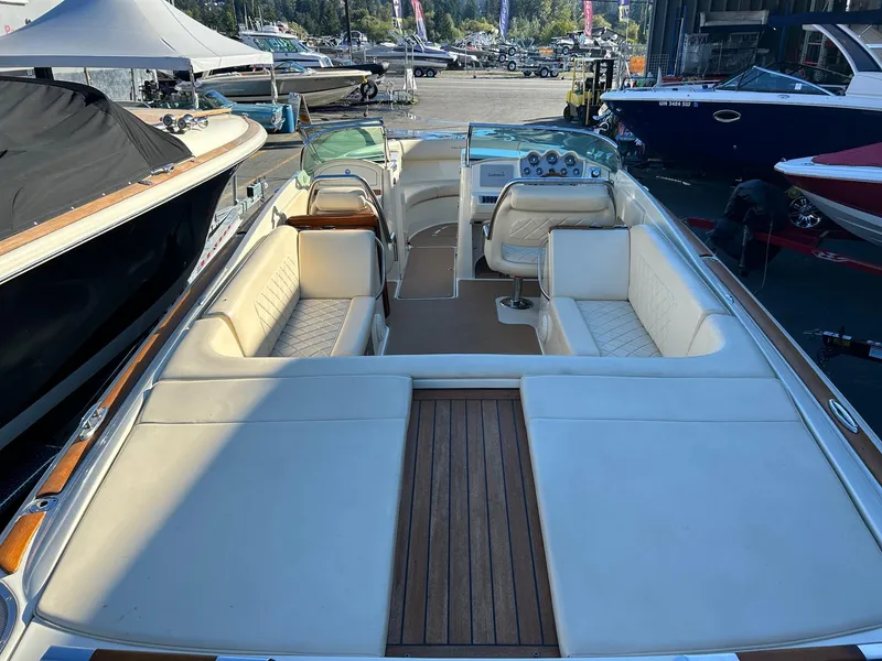 Slide: The Image of 2015 Chris-Craft Launch 28 boat with luxurious seating and wooden deck, docked at marina. - 8