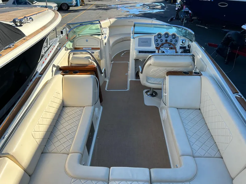Slide: The Image of 2015 Chris-Craft Launch 28 boat interior with luxurious white seating and elegant dashboard. - 9