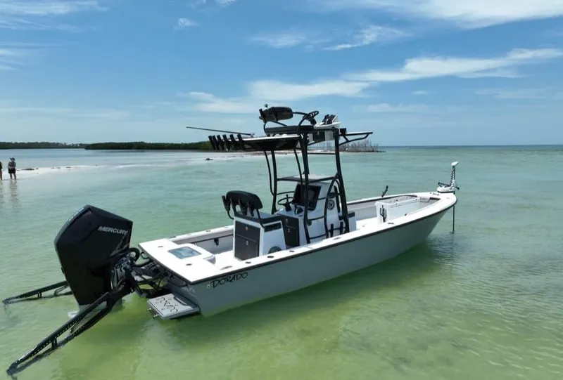 Slide: The Image of 2022 Dorado 25 Flat Deck boat in clear, shallow water under a blue sky. - 6