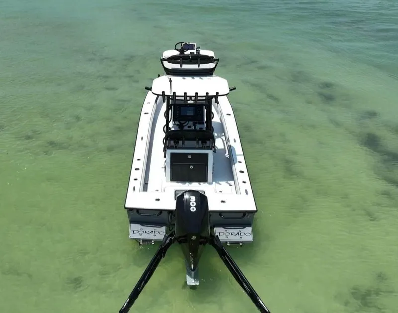 Slide: The Image of 2022 Dorado 25 Flat Deck boat on clear water, rear view. - 7