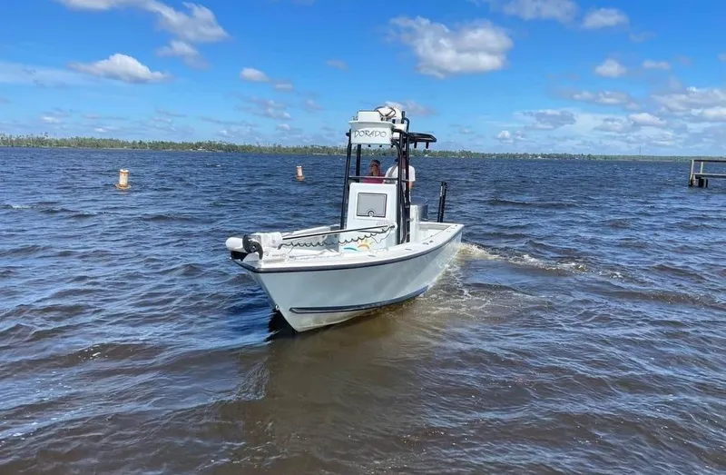 Slide: The Image of 2019 Dorado 25 Flat Deck boat cruising on a sunny day. - 2
