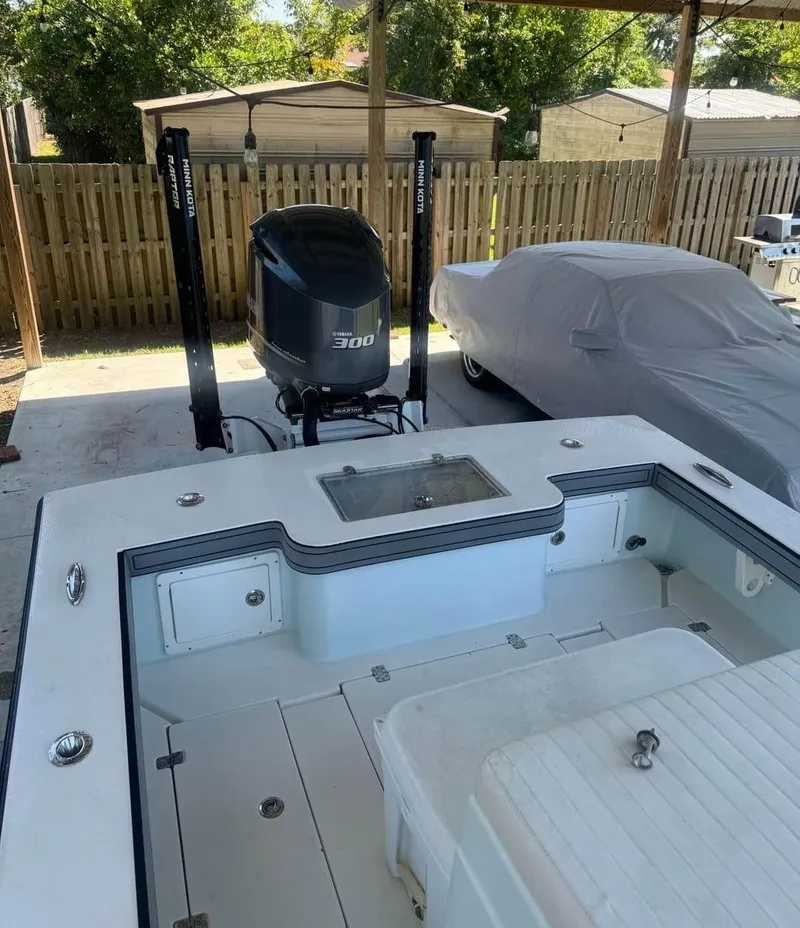 Slide: The Image of 2019 Dorado 25 Flat Deck boat with powerful 300 HP engine in a covered area. - 3