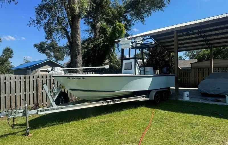 Slide: The Image of 2019 Dorado 25 Flat Deck boat on trailer, parked in a grassy yard. - 5