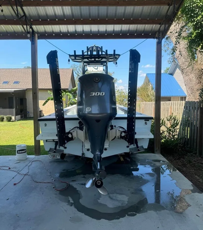 Slide: The Image of 2019 Dorado 25 Flat Deck boat with 300 HP engine under a metal canopy. - 6