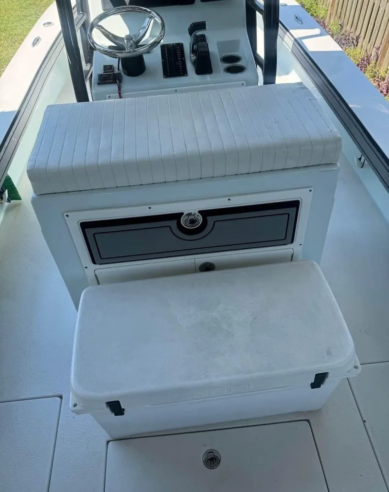 Slide: The Image of 2019 Dorado 25 Flat Deck boat interior with steering wheel and storage compartments. - 8
