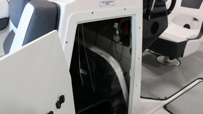 Slide: The Image of 2025 Yamaha AR195 boat interior storage compartment with open door. - 13