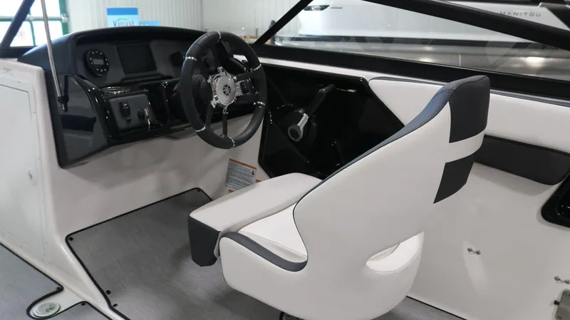 Slide: The Image of 2025 Yamaha Boats AR195 interior with steering wheel and captain's chair. - 18