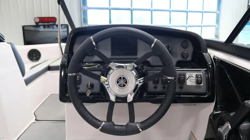 Slide: The Image of 2025 Yamaha AR195 boat steering wheel and dashboard interior. - 19