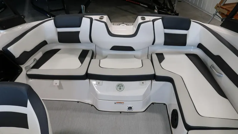 Slide: The Image of 2025 Yamaha Boats AR195 interior seating with sleek black and white upholstery. - 22