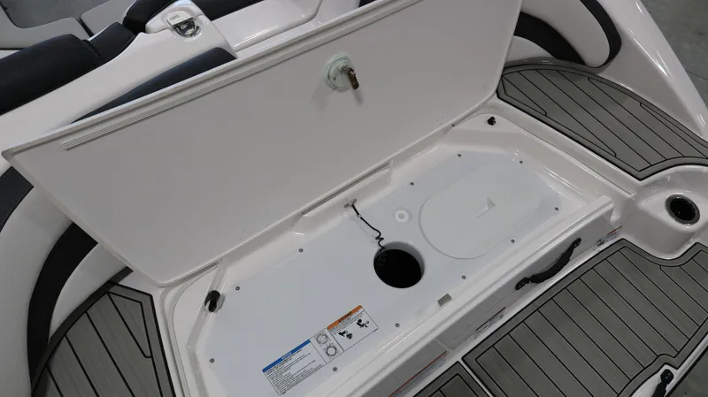 Slide: The Image of 2025 Yamaha AR195 boat storage compartment with open hatch, showcasing interior details. - 27