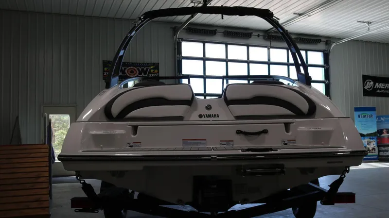 Slide: The Image of 2025 Yamaha AR195 boat in a showroom, rear view. - 5