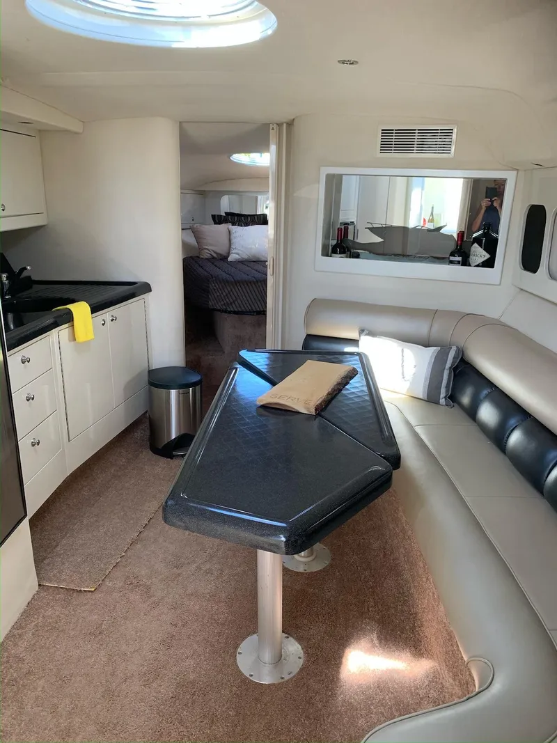 Slide: The Image of Interior of a 1996 Wellcraft 45 Excalibur yacht with modern seating and kitchenette. - 12