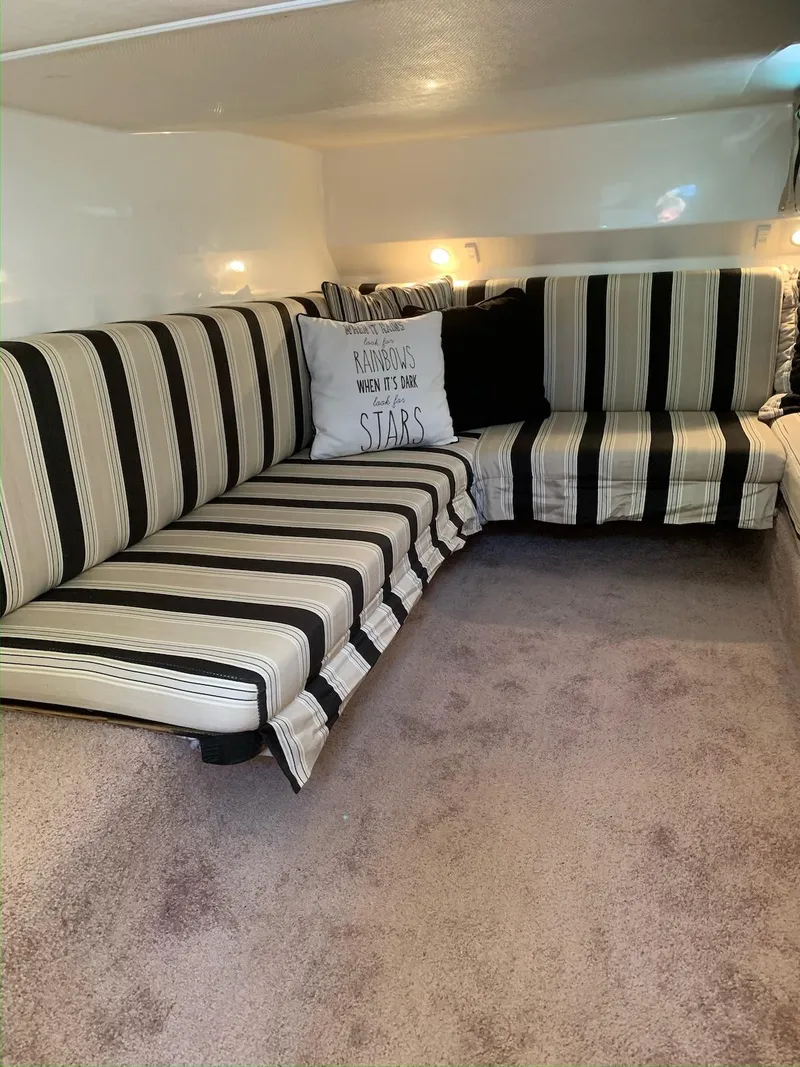 Slide: The Image of Striped seating area inside 1996 Wellcraft 45 Excalibur boat with cozy cushions. - 16