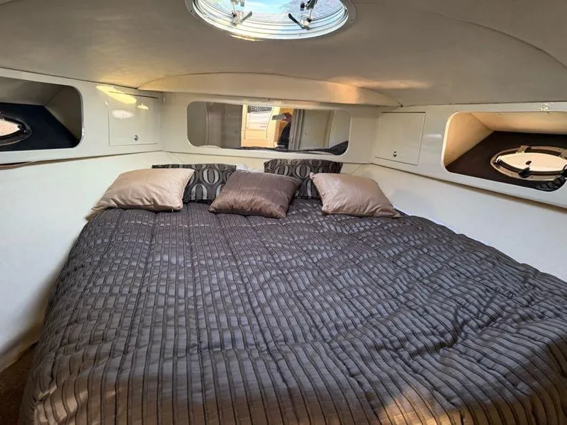 Slide: The Image of Interior cabin of 1996 Wellcraft 45 Excalibur with cozy bed and pillows. - 20