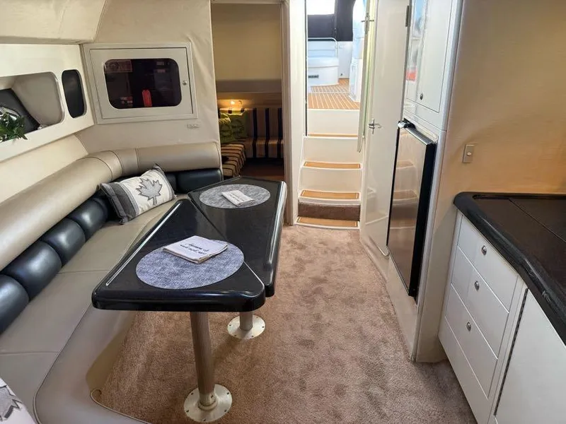 Slide: The Image of Interior of a 1996 Wellcraft 45 Excalibur yacht with dining area and kitchenette. - 21