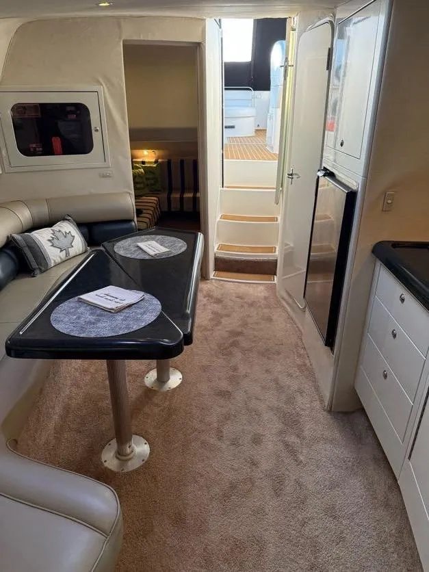 Slide: The Image of Interior of 1996 Wellcraft 45 Excalibur yacht with seating, table, and kitchenette. - 22