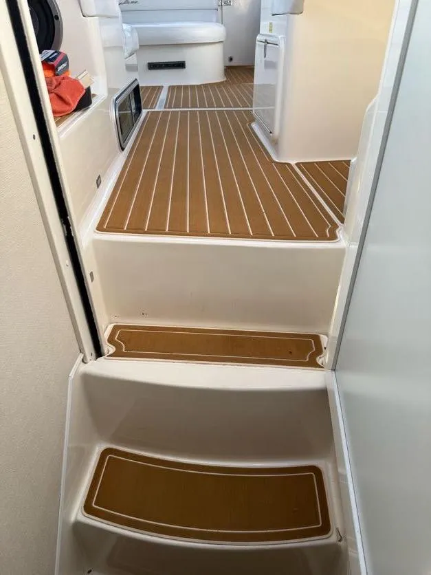 Slide: The Image of Interior view of 1996 Wellcraft 45 Excalibur boat with wooden flooring and white seating. - 23