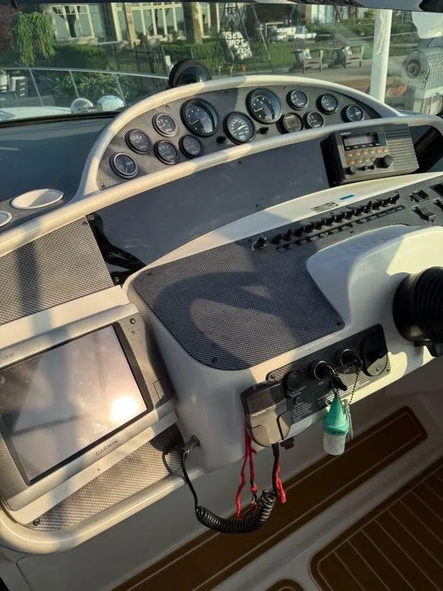 Slide: The Image of Control panel of a 1996 Wellcraft 45 Excalibur boat with gauges and navigation equipment. - 24