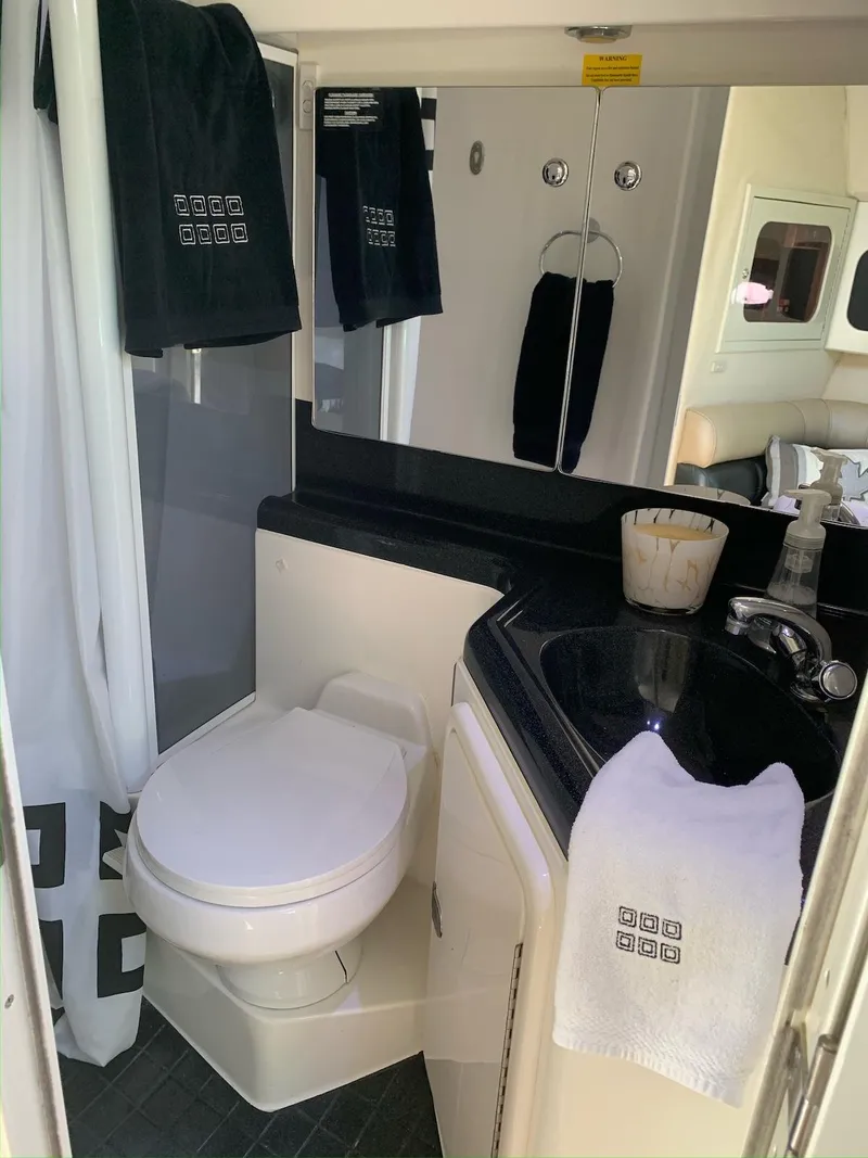 Slide: The Image of Bathroom interior of 1996 Wellcraft 45 Excalibur yacht with toilet, sink, and mirror. - 29