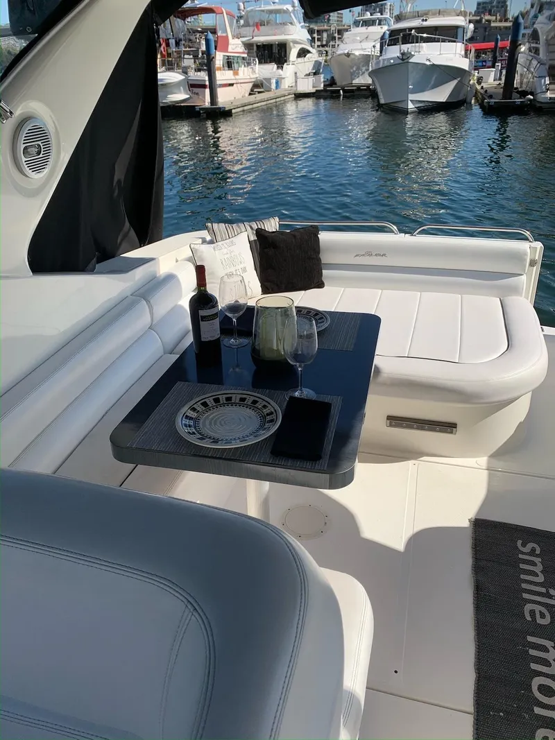 Slide: The Image of Luxury dining setup on 1996 Wellcraft 45 Excalibur yacht, docked at marina. - 5