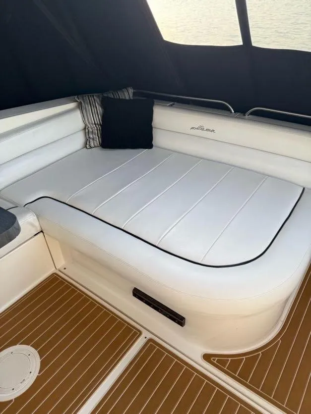 Slide: The Image of 1996 Wellcraft 45 Excalibur interior with white cushioned seating and wooden flooring. - 7