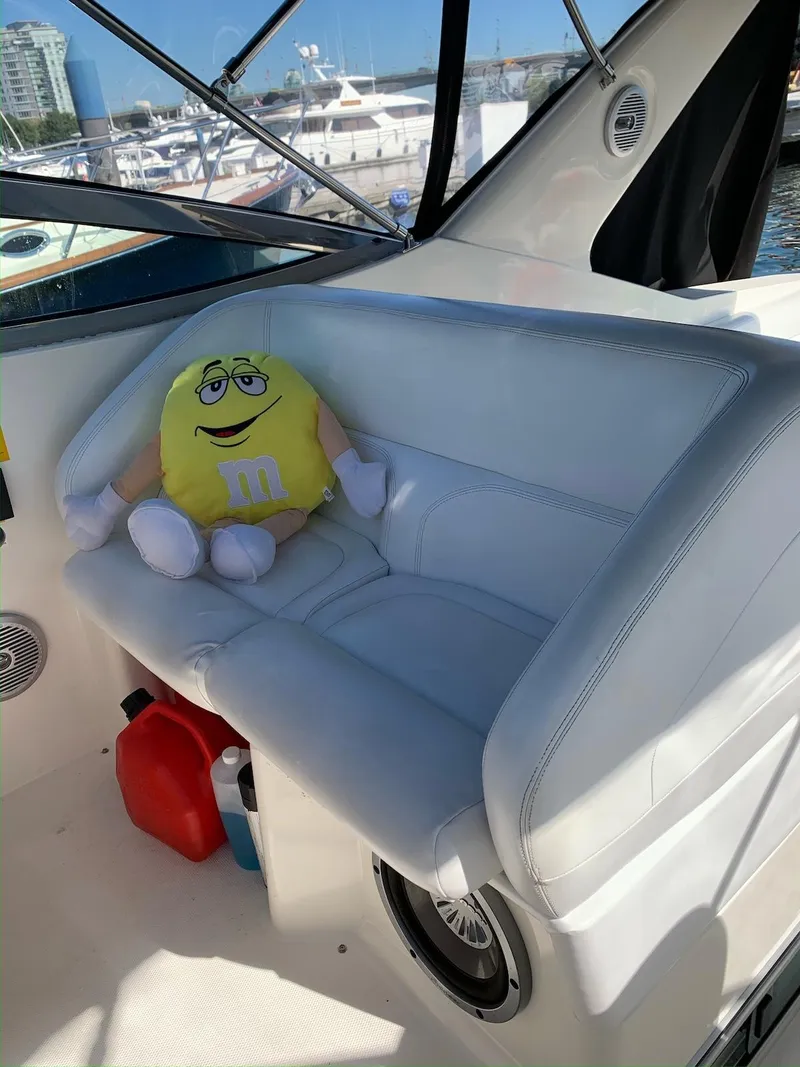 Slide: The Image of 1996 Wellcraft 45 Excalibur interior with plush toy on white leather seat. - 8